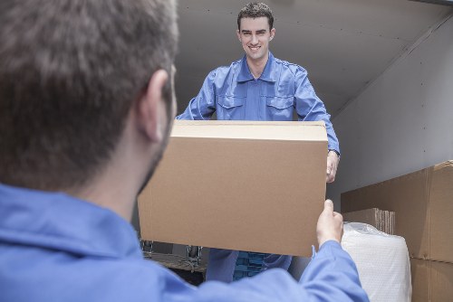 House removal team preparing to move furniture in an Ilford residential street